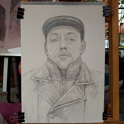 Artists drawing a portrait. Young woman portrait drawn in pencil